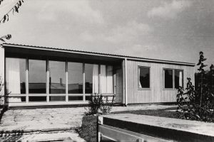 black and white photo with bungalow with glass front