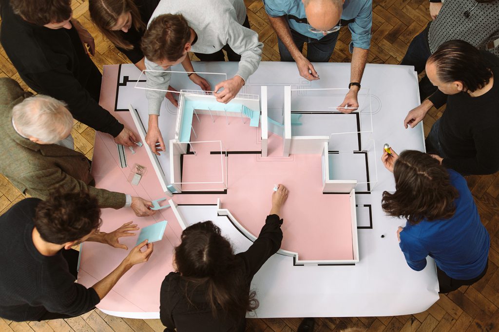 View from above of an architectural model and some people around it