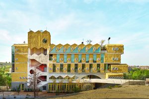 Building in ochre yellow with small porthole windows